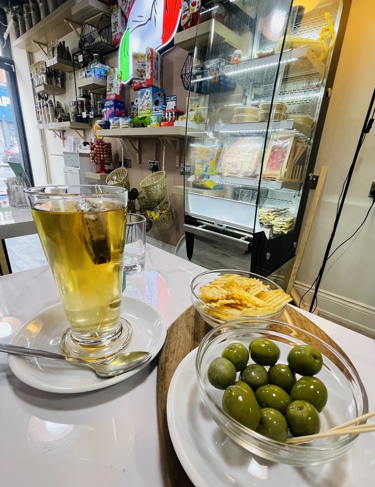 Green olives and crisps with a glass of tea